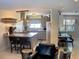 Open living area, view of kitchen with stainless steel appliances, island, and bar seating at 201 79Th Ne Ave, St Petersburg, FL 33702