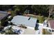 Rear exterior featuring a well-maintained yard with a waterfront view and a new gray roof at 201 79Th Ne Ave, St Petersburg, FL 33702