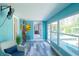 Bright sunroom with multiple windows, comfortable seating, and waterfront views at 201 79Th Ne Ave, St Petersburg, FL 33702