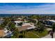 Aerial view of waterfront home with well-manicured lawn, mature palms, and a swimming pool in the backyard at 2340 W Bay Isle Se Dr, St Petersburg, FL 33705