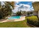 Beautiful pool and backyard with mature landscaping and ample lounging space at 2340 W Bay Isle Se Dr, St Petersburg, FL 33705