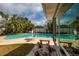 Backyard pool area surrounded by tropical palms and a privacy fence at 2340 W Bay Isle Se Dr, St Petersburg, FL 33705