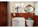 Charming bathroom with red tiled walls, a shower, and decorative mirrors at 2340 W Bay Isle Se Dr, St Petersburg, FL 33705