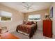 Cozy bedroom with natural light, ceiling fan, and classic wooden dresser at 2340 W Bay Isle Se Dr, St Petersburg, FL 33705