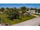 Charming single-story home with lush landscaping, mature trees, and a well-maintained lawn at 2340 W Bay Isle Se Dr, St Petersburg, FL 33705