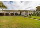 Inviting single-story home with a well-maintained lawn and covered porch, perfect for relaxing outdoors at 2340 W Bay Isle Se Dr, St Petersburg, FL 33705