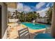 Backyard pool, patio and seating area surrounded by lush, mature landscaping at 2340 W Bay Isle Se Dr, St Petersburg, FL 33705