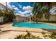 Lush backyard pool with sunbathing area surrounded by mature landscaping at 2340 W Bay Isle Se Dr, St Petersburg, FL 33705