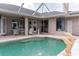 Private screened-in pool and patio area with lounge furniture and dolphin fountain at 2355 Mission Valley Blvd, Nokomis, FL 34275