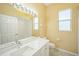 Bathroom featuring double sink vanity with modern lighting and fixtures at 2414 115Th E Ter, Parrish, FL 34219