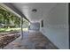 Covered back porch with stone tile flooring, providing ample space for outdoor seating and relaxation at 2710 W Osborne Ave # 1, Tampa, FL 33614