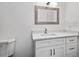 Clean bathroom showcasing a modern vanity with storage and a framed mirror, complemented by neutral-toned fixtures and finishes at 2710 W Osborne Ave # 1, Tampa, FL 33614
