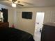 Bedroom showcases an open en-suite bathroom and mounted TV, offering convenience and modern living at 2710 W Osborne Ave # 1, Tampa, FL 33614