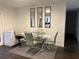Dining area featuring a glass table with seating for four, modern light fixtures and dark wood flooring at 2710 W Osborne Ave # 1, Tampa, FL 33614