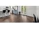 Kitchen with a stainless steel refrigerator, island with seating, and dark wood flooring at 2710 W Osborne Ave # 1, Tampa, FL 33614