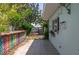 Outdoor patio with a view of the waterfront and dock, featuring colorful breeze block wall at 300 Westwinds Dr, Palm Harbor, FL 34683
