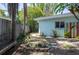 The backyard includes a stone fire pit and a view of the home's exterior at 300 Westwinds Dr, Palm Harbor, FL 34683