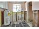 Bathroom needing renovation, featuring a water heater and window with natural light at 300 Westwinds Dr, Palm Harbor, FL 34683