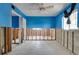 Bedroom with bright blue walls, unfinished areas, and natural light from two windows at 300 Westwinds Dr, Palm Harbor, FL 34683