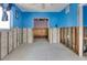Bedroom with bright blue walls, unfinished areas, and abundant natural light at 300 Westwinds Dr, Palm Harbor, FL 34683