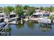 Waterfront view featuring a boat dock and outdoor entertainment area at 300 Westwinds Dr, Palm Harbor, FL 34683