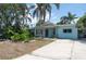 Charming single-story home with mature trees and a concrete driveway at 300 Westwinds Dr, Palm Harbor, FL 34683