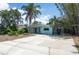 Charming single-story home with mature trees and a concrete driveway at 300 Westwinds Dr, Palm Harbor, FL 34683