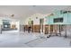 Open-concept kitchen with dining area, tile floors, and unfinished walls awaiting personalization at 300 Westwinds Dr, Palm Harbor, FL 34683