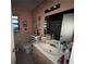 A well-lit bathroom featuring a white sink, vanity, toilet, a large mirror and decorative wall decor at 3111 W Spruce St, Tampa, FL 33607
