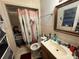 A full bathroom featuring a shower, toilet, and vanity with a mirror at 3111 W Spruce St, Tampa, FL 33607