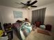 Bedroom with tile floors, ceiling fan, and a window with curtains and a landscape painting above the bed at 3111 W Spruce St, Tampa, FL 33607