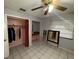Bedroom featuring tiled floor, a ceiling fan and a closet with peach-colored interior walls and red curtain at 3111 W Spruce St, Tampa, FL 33607