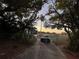 Long driveway with chain link fence leading to a blue house at 3111 W Spruce St, Tampa, FL 33607
