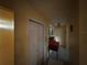 View of a hallway featuring tiled floors, a table with decor, and closet with folding doors at 3111 W Spruce St, Tampa, FL 33607