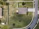 Attractive aerial view displaying a large yard, privacy fence, and well-kept landscaping at 3303 Ranchdale Dr, Plant City, FL 33566