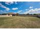 Large fenced backyard with ample green space, screened-in patio, and privacy for outdoor enjoyment at 3303 Ranchdale Dr, Plant City, FL 33566