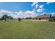 Large, grassy fenced backyard offering plenty of room and privacy at 3303 Ranchdale Dr, Plant City, FL 33566