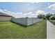 A backyard featuring a tall fence for privacy and a well-maintained lawn at 3303 Ranchdale Dr, Plant City, FL 33566