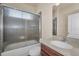 Functional bathroom featuring shower-tub combination with glass doors and vanity at 3303 Ranchdale Dr, Plant City, FL 33566