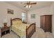Cozy bedroom features a comfortable bed with tropical themed bedding and traditional wooden furnishings at 3303 Ranchdale Dr, Plant City, FL 33566