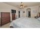 Comfortable bedroom with large bed, television, fan and neutral walls and carpet at 3303 Ranchdale Dr, Plant City, FL 33566