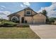 Inviting two-story home featuring a two-car garage and professionally landscaped front yard at 3303 Ranchdale Dr, Plant City, FL 33566