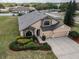 Aerial view of a well-maintained house with a manicured lawn, two car garage, and stone facade at 3303 Ranchdale Dr, Plant City, FL 33566