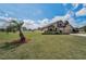 Attractive exterior of a two-story home with lush green lawn and a palm tree at 3303 Ranchdale Dr, Plant City, FL 33566