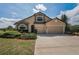 Charming two-story home with stone accents, three-car garage, and manicured landscaping at 3303 Ranchdale Dr, Plant City, FL 33566
