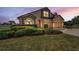 Beautiful home exterior at twilight with stone accents and landscaped front yard at 3303 Ranchdale Dr, Plant City, FL 33566