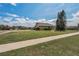 Well-maintained lawn, landscaped bushes, and lush trees complement the charming house exterior at 3303 Ranchdale Dr, Plant City, FL 33566
