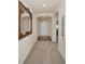 Welcoming hallway with neutral walls, carpet flooring, and decorative mirror at 3303 Ranchdale Dr, Plant City, FL 33566