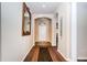 Welcoming hallway with arched doorways, decorative mirror, and stylish flooring at 3303 Ranchdale Dr, Plant City, FL 33566