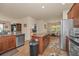 Well-lit kitchen featuring an island, stainless steel appliances, and tiled floors at 3303 Ranchdale Dr, Plant City, FL 33566